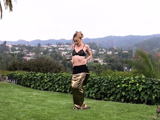 Petite blondie posing nude in the garden